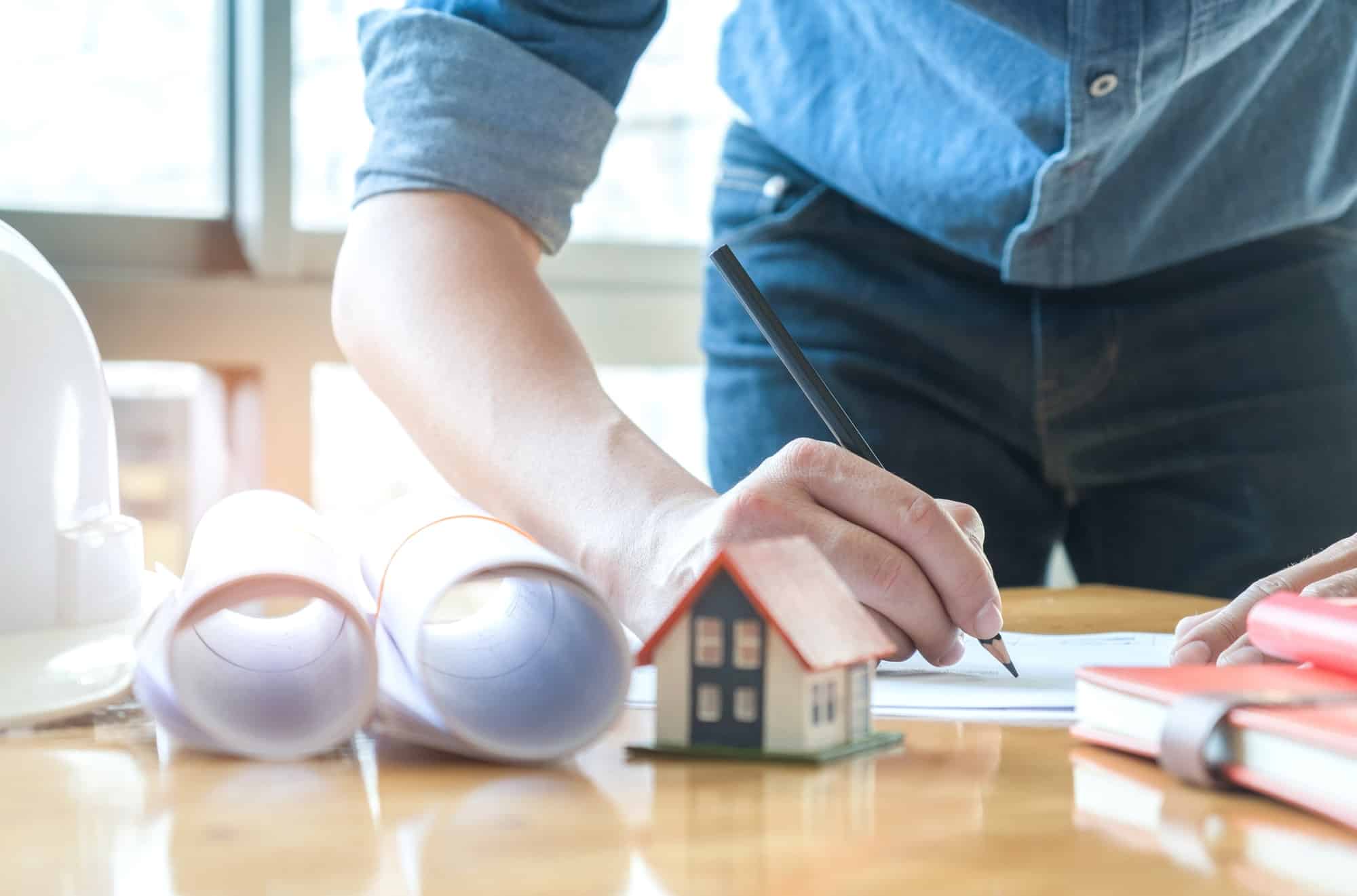 Home design concepts,Male architects are pencil drawing.